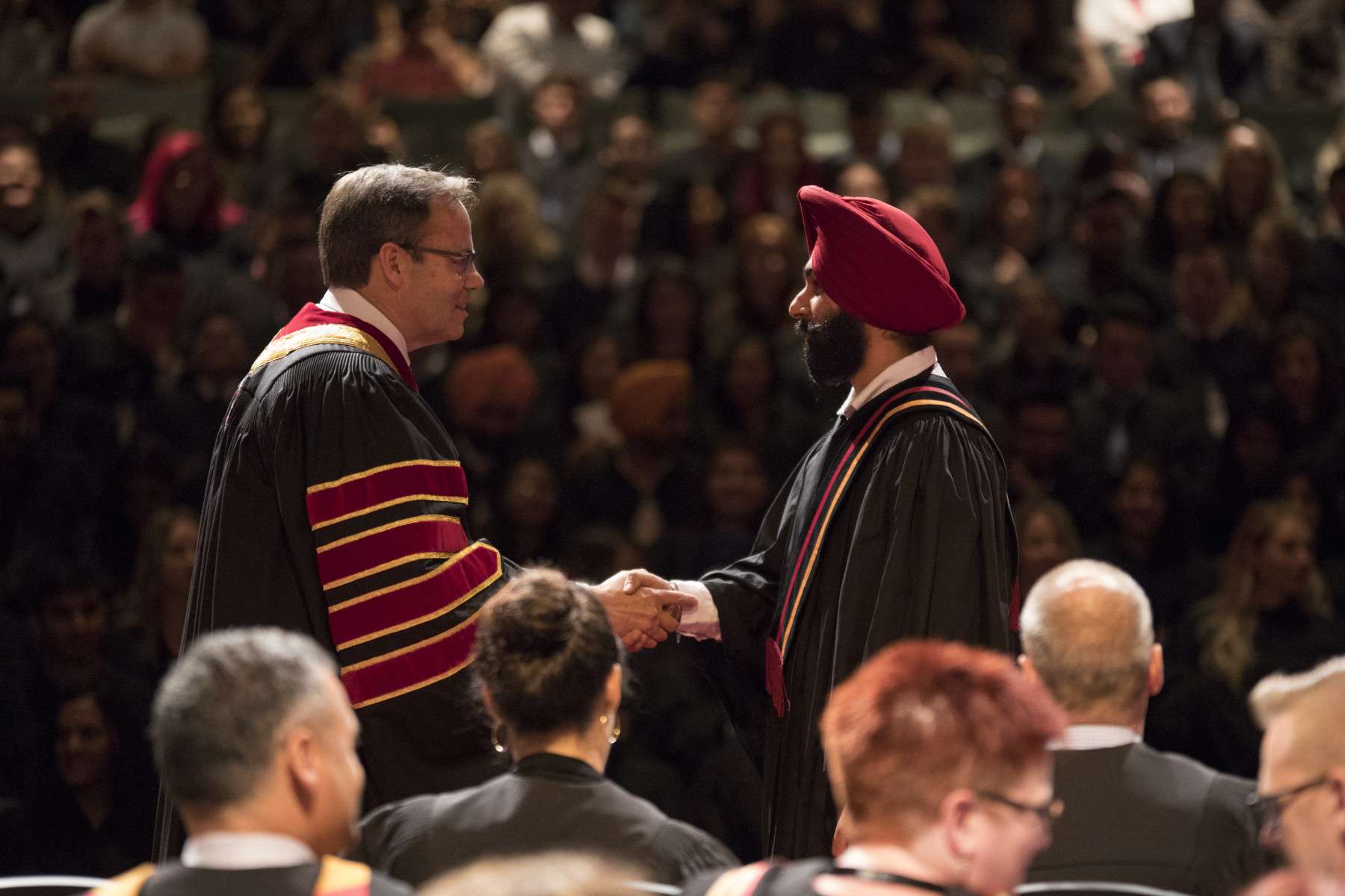 Mohawk College president Ron McKerlie, left, says it was a privilege to congratulate thousands of students every year as they crossed the convocation stage to accept their diplomas. COURTESY OF MOHAWK COLLEGE
